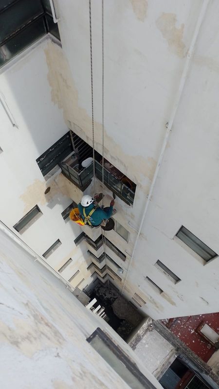 Vista cenital de trabajo de albañilería con cuerdas en pozo de aire y luz, Belgrano